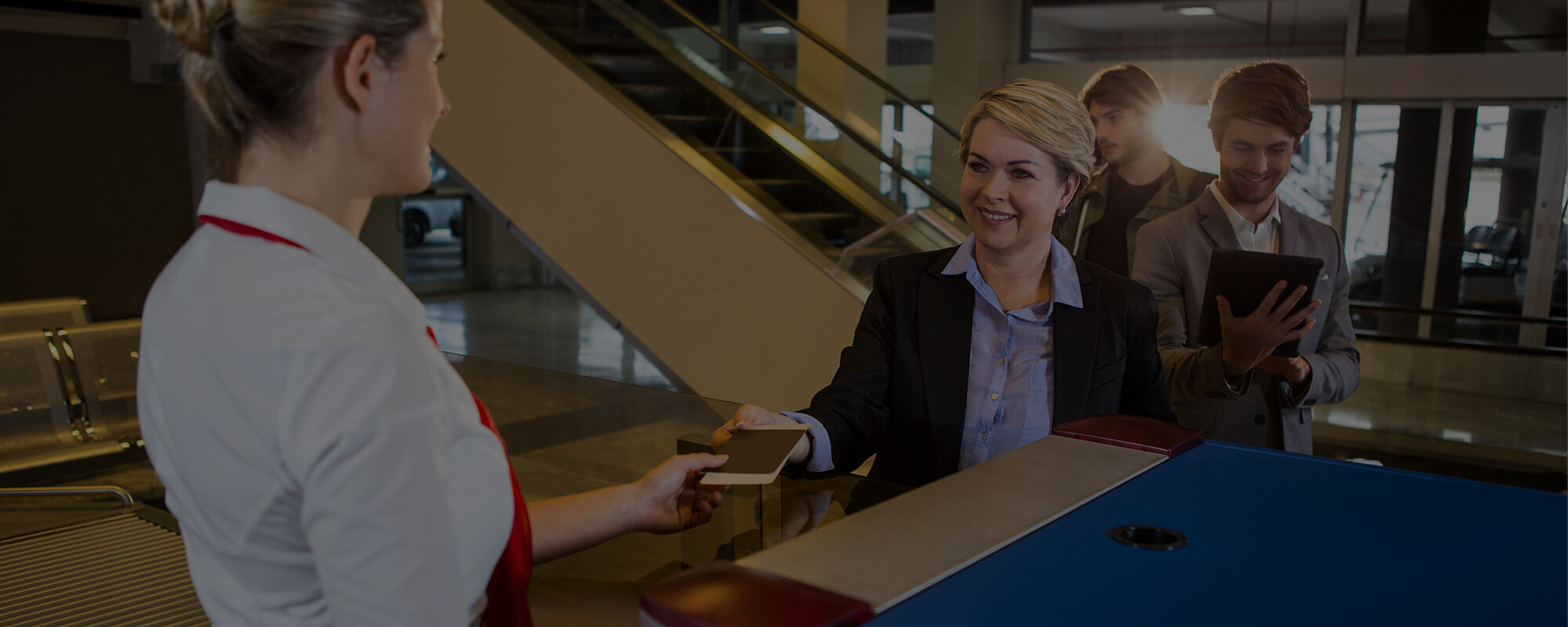 Traveler being assisted at an airport, symbolizing the support and guidance provided through CIBT's Guided-Entry services.